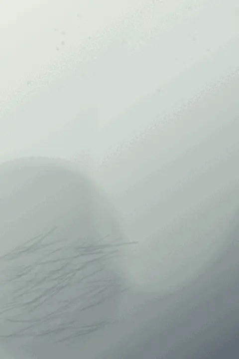 Fault in the Utterance: cumulative painting state 1 of 3; A cold, nearly white portrait carries a diagonal descent of graphite-like slivers, faint red powder branches, and soft blue-gray atmospheric fields with large unused paper above.