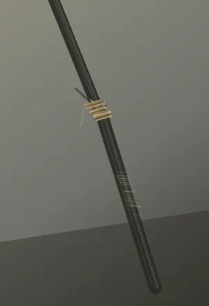 The Staff Takes Weight: cumulative painting state 3 of 4; A broken dark shaft runs diagonally through a tall quiet field, repaired with unequal pale lashings and weighted by a cropped hand into earth.